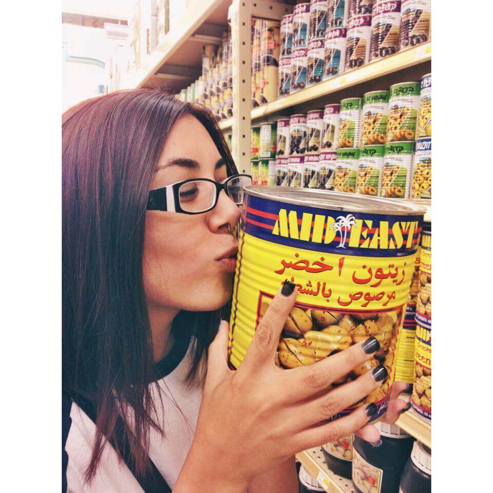 peta2 staffer kissing a can of food at the grocery store