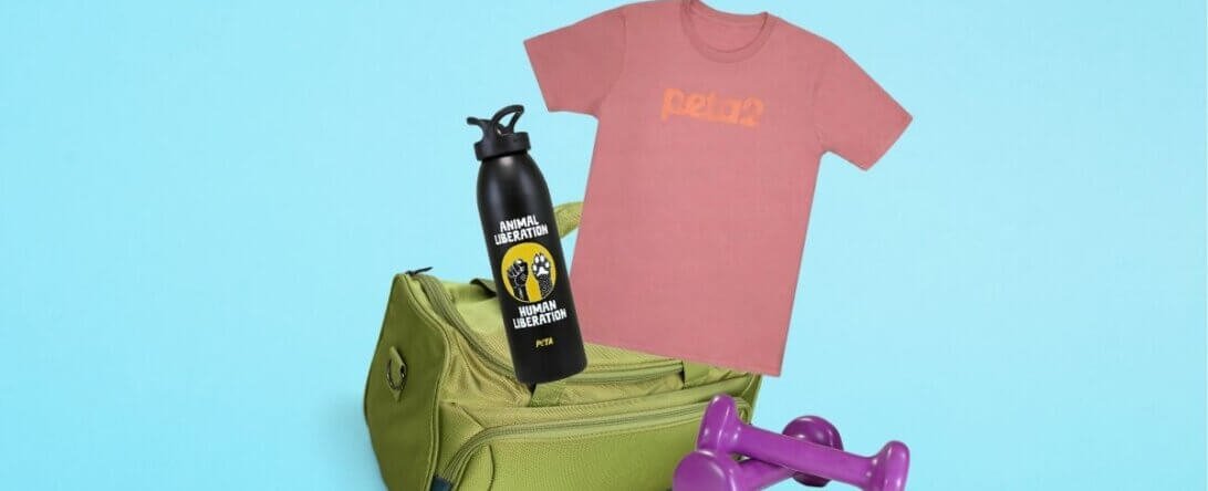 Gym bag and weights with a peta2 logo shirt and a water bottle with an "Animal Liberation" message