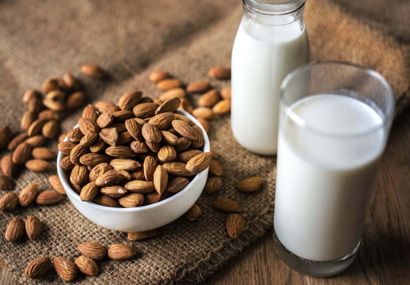 Almond milk alongside almonds