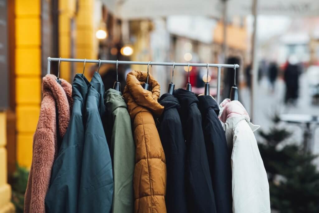 Various coats and jackets hang from a rack