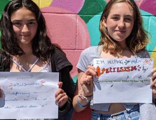 interns holding signs to help end speciesism