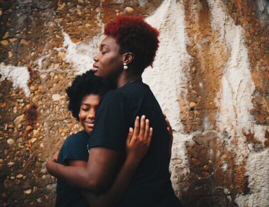 Parent and teen hugging