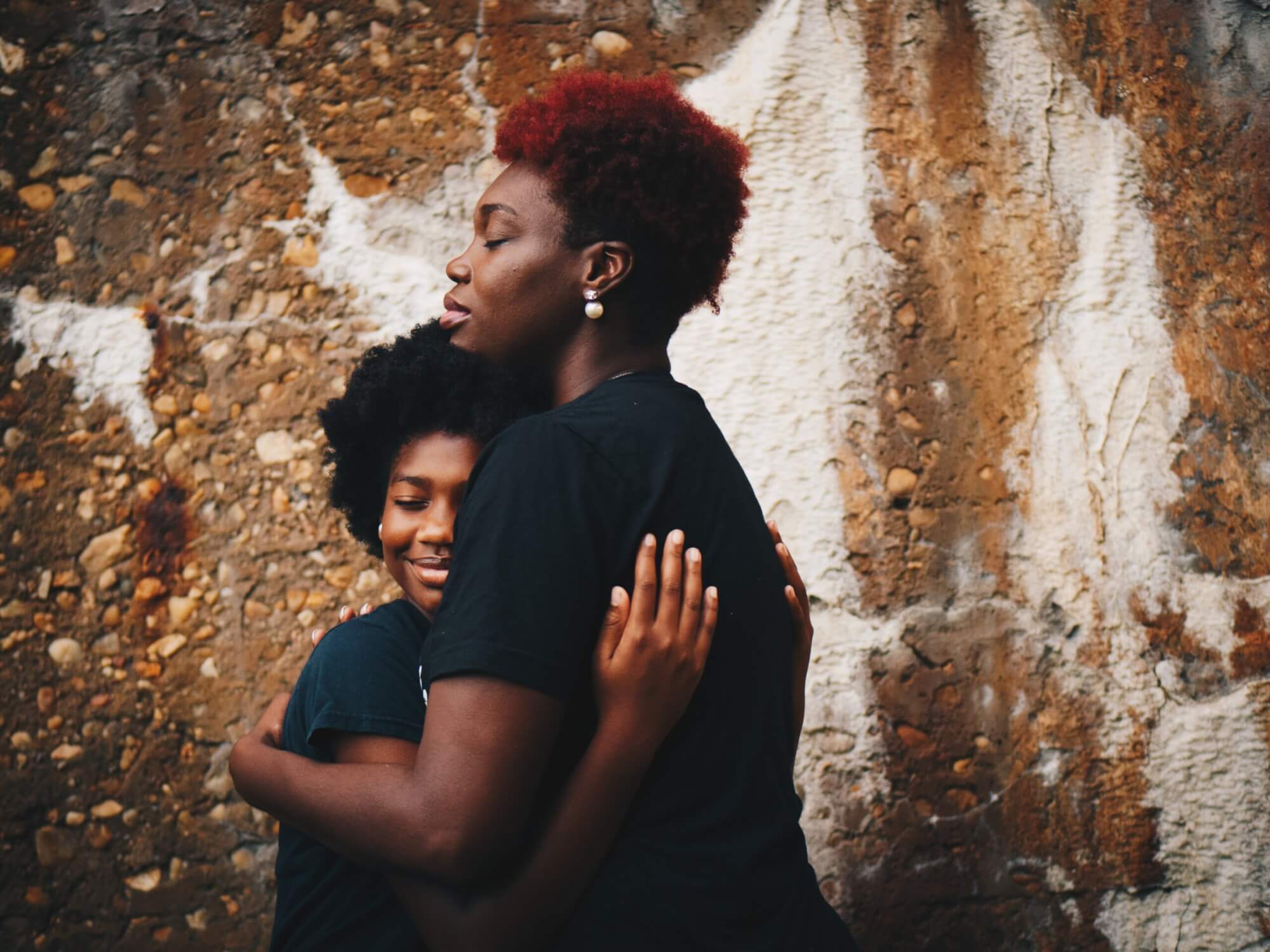 Parent and teen hugging