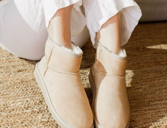 A model wears a pair of vegan sheepskin boots