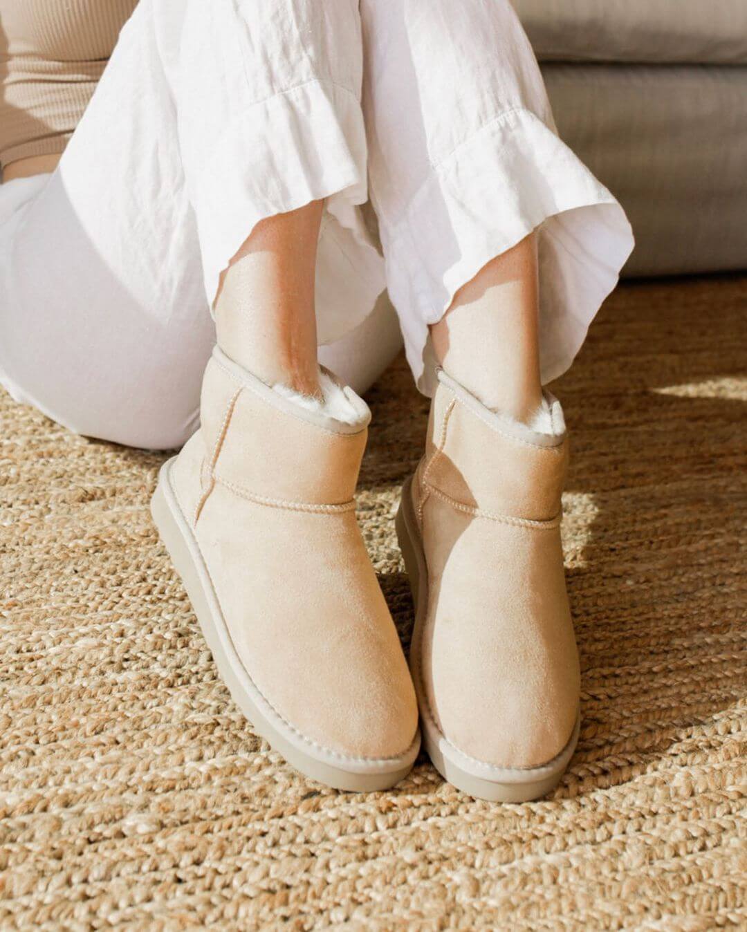 A model wears a pair of vegan sheepskin boots