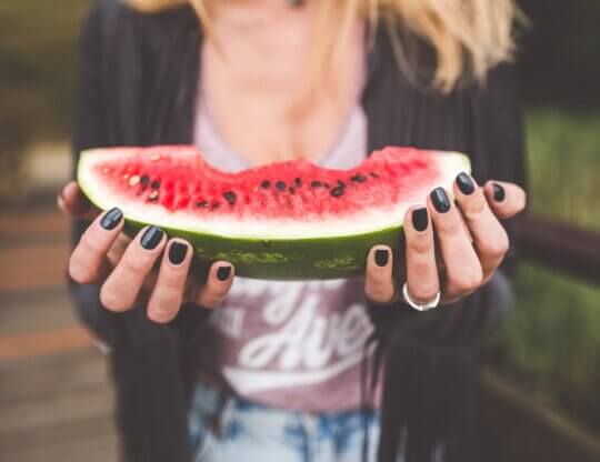 Young person eating a watermelon