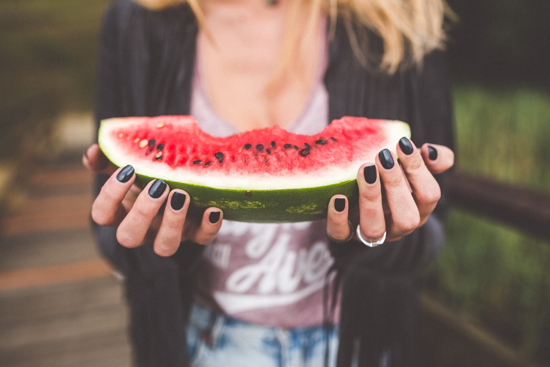 Young person eating a watermelon