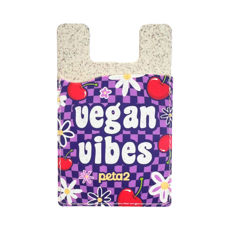A purple phone card holder that reads "Vegan vibes" with illustrations of flowers and cherries