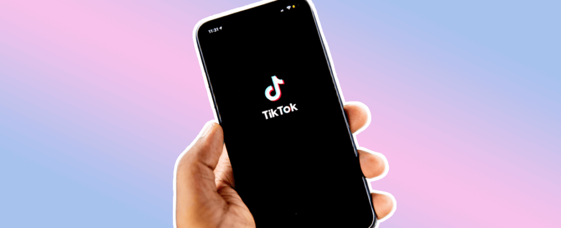 Hand holding a cell phone with TikTok