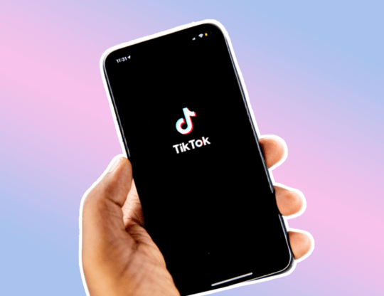 Hand holding a cell phone with TikTok