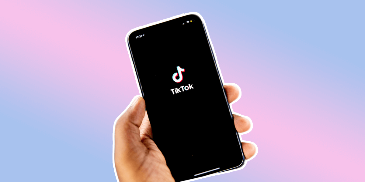 Hand holding a cell phone with TikTok