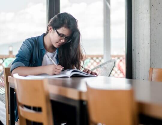 Image from Unsplash of a person writing